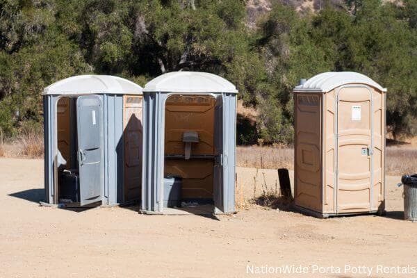 a clean row of portable restrooms for outdoor weddings or festivals in Honeyville, UT